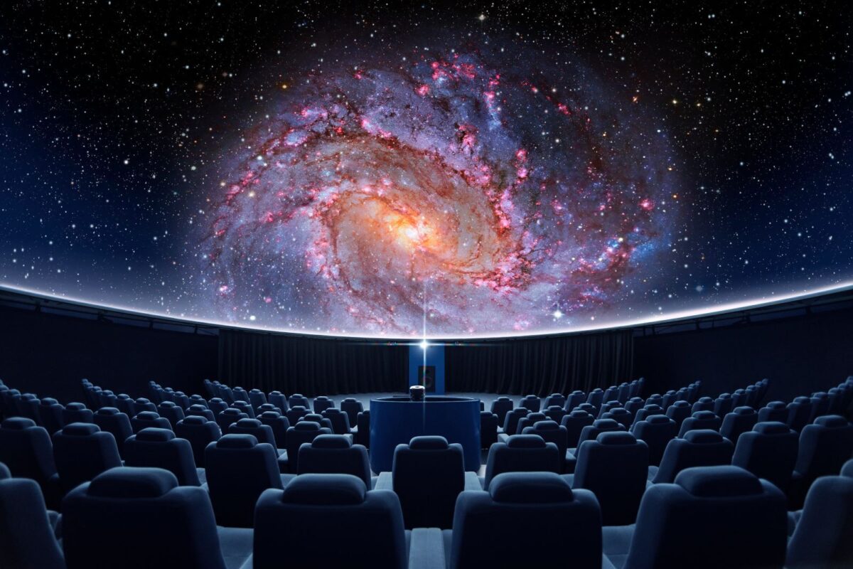 A galaxy is projected in an empty planetarium.