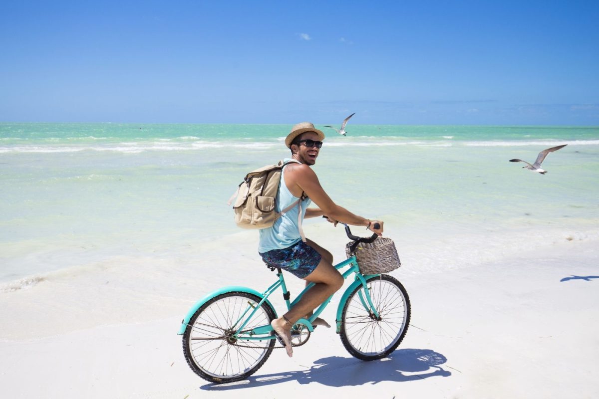 Man riding bike on beach